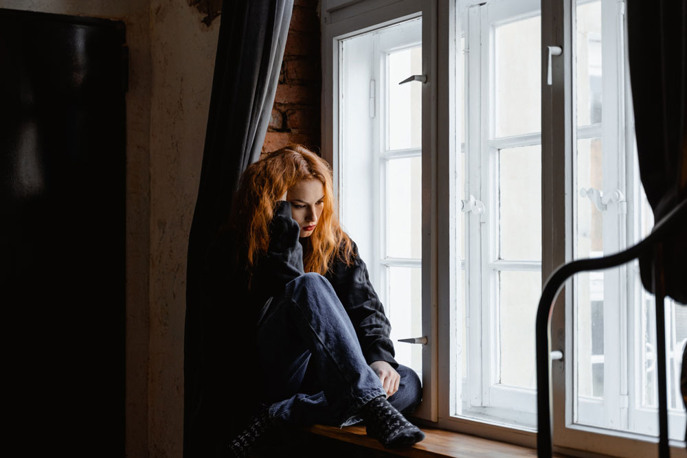 Photo by MART PRODUCTION from Pexels: https://www.pexels.com/photo/woman-in-black-leather-jacket-sitting-on-brown-wooden-floor-7277896/